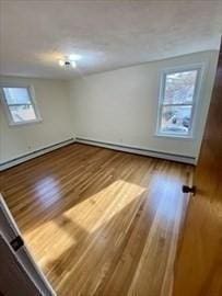 unfurnished room with wood-type flooring