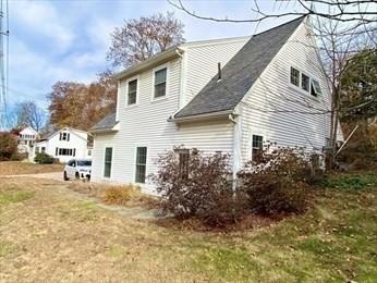 rear view of house with a yard