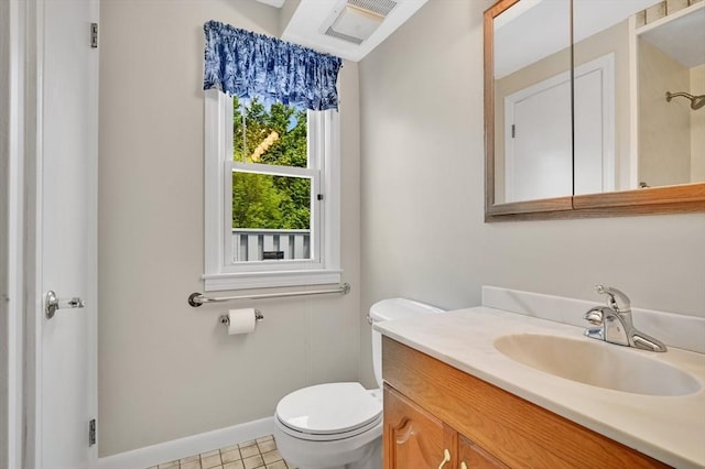 bathroom featuring toilet, baseboards, and vanity