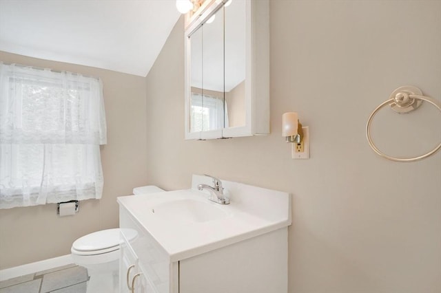 half bathroom with toilet, vanity, and baseboards