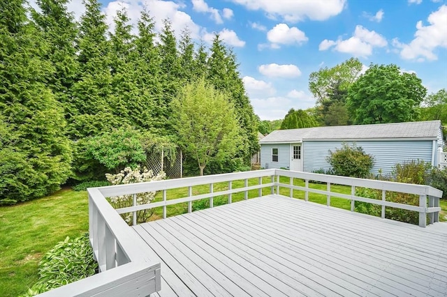 wooden deck featuring a lawn