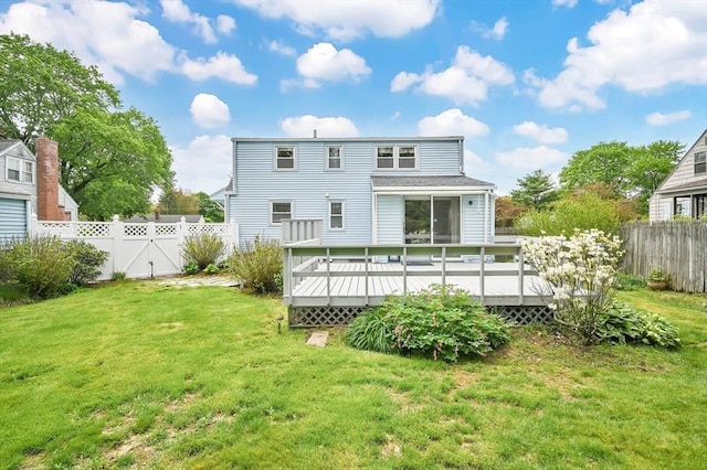 back of property featuring a wooden deck and a gate