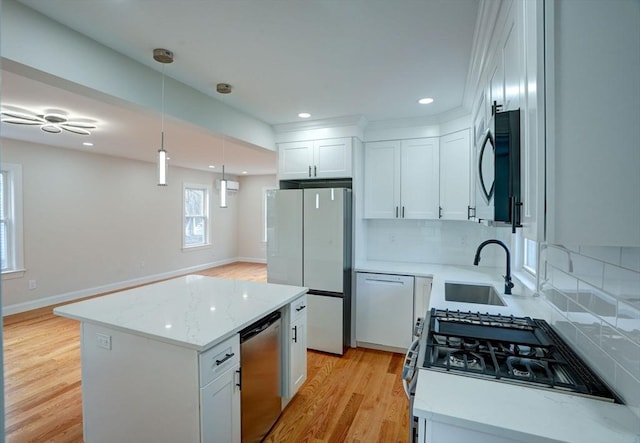 kitchen with a center island, backsplash, white cabinets, sink, and stainless steel appliances