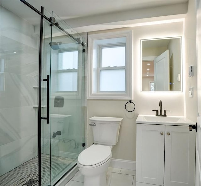 bathroom with tile patterned flooring, vanity, an enclosed shower, and toilet