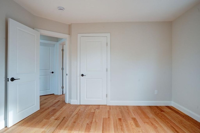 unfurnished bedroom with light hardwood / wood-style floors and a closet