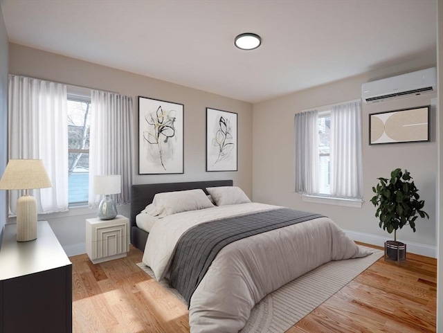 bedroom featuring a wall mounted air conditioner, light hardwood / wood-style floors, and multiple windows