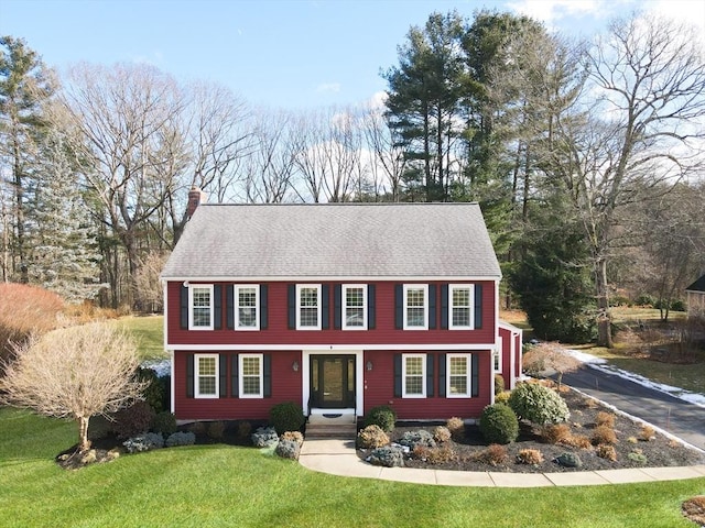 colonial-style house with a front yard