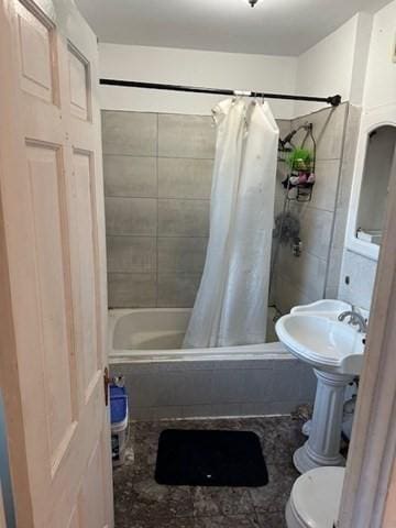 bathroom with toilet and shower / tub combo with curtain