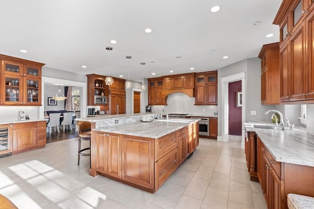 kitchen with recessed lighting, brown cabinets, and a sink