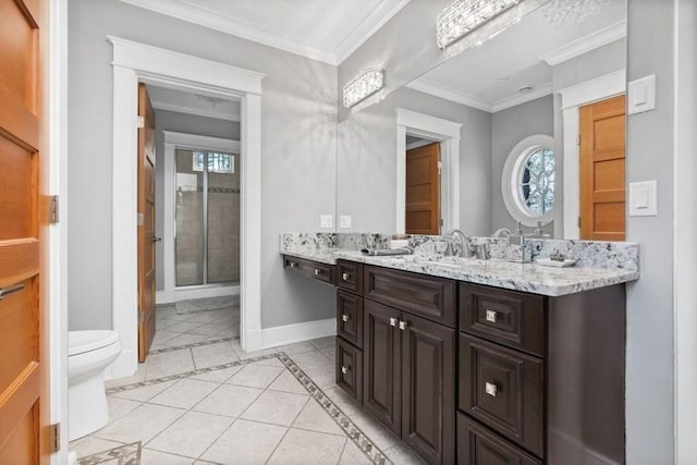 full bath with baseboards, toilet, double vanity, ornamental molding, and a sink