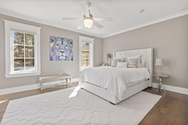 bedroom featuring dark wood-style flooring, ceiling fan, baseboards, and ornamental molding