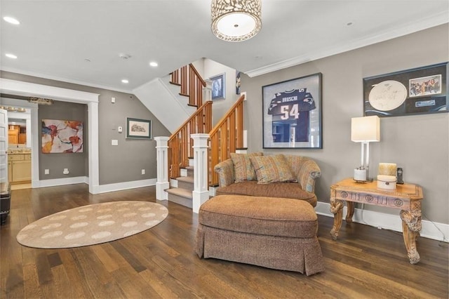 sitting room featuring stairway, wood finished floors, and ornamental molding