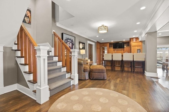 interior space with crown molding, recessed lighting, baseboards, and wood-type flooring