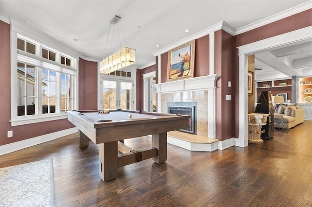 playroom with crown molding, wood finished floors, baseboards, and a premium fireplace