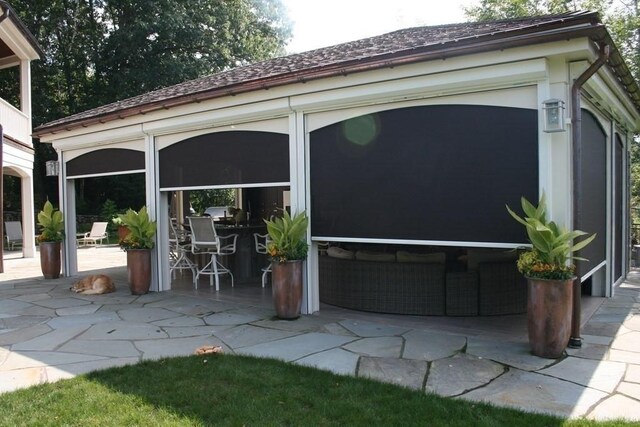 view of patio with a sunroom