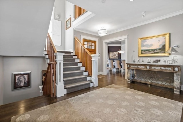 stairway featuring wood finished floors and crown molding