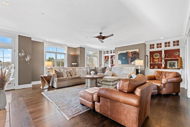 living room with a wealth of natural light, ornamental molding, and dark wood-style flooring