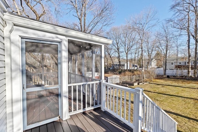 wooden deck featuring a sunroom, a garden, and a yard