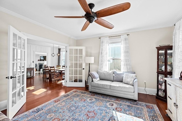 living area with french doors, crown molding, baseboards, and wood finished floors