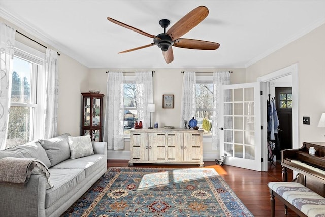 living room featuring a healthy amount of sunlight, crown molding, and wood finished floors