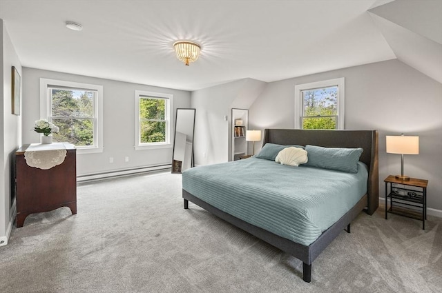 bedroom featuring a baseboard heating unit, multiple windows, carpet flooring, and baseboards