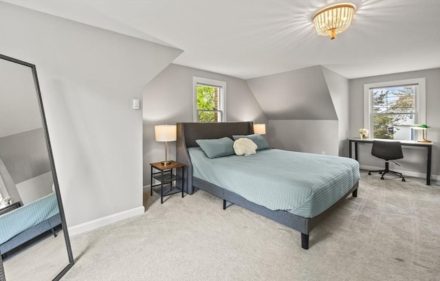 carpeted bedroom with baseboards, lofted ceiling, and an office area