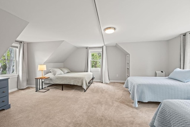 bedroom with baseboards, light carpet, and lofted ceiling