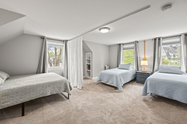 bedroom with vaulted ceiling and light colored carpet