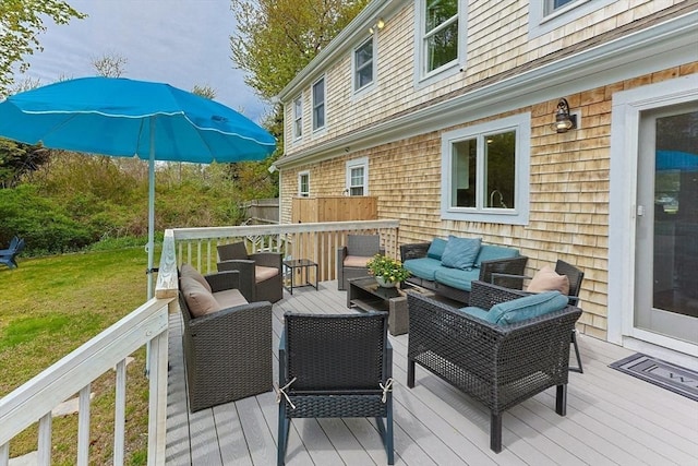 wooden deck featuring outdoor lounge area and a lawn