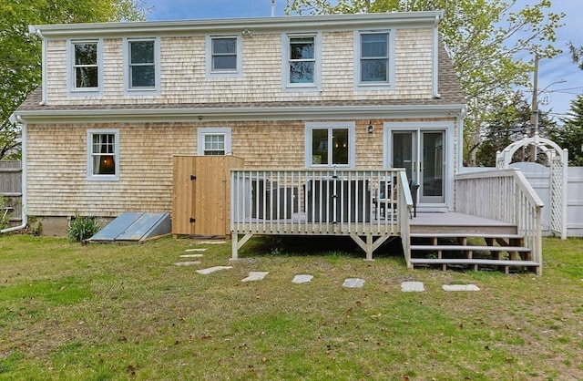 back of house with a wooden deck and a yard
