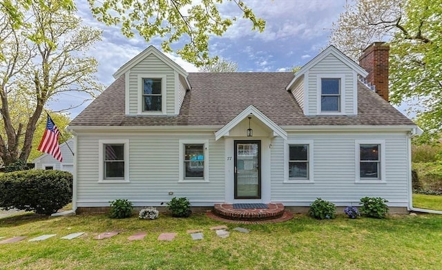 cape cod-style house with a front yard, roof with shingles, and a chimney