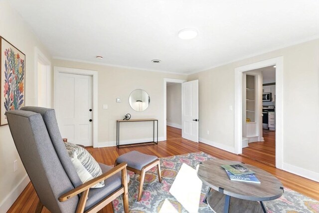 sitting room featuring baseboards and wood finished floors