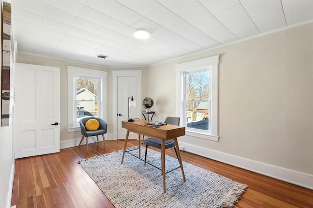 office with visible vents, baseboards, wood finished floors, and crown molding