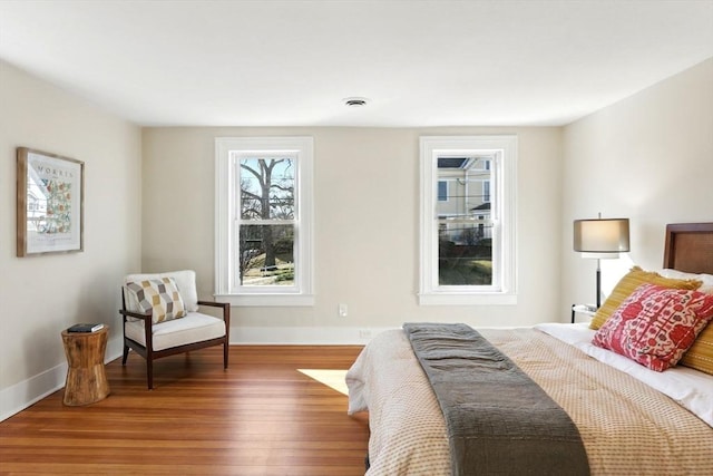 bedroom with baseboards and wood finished floors