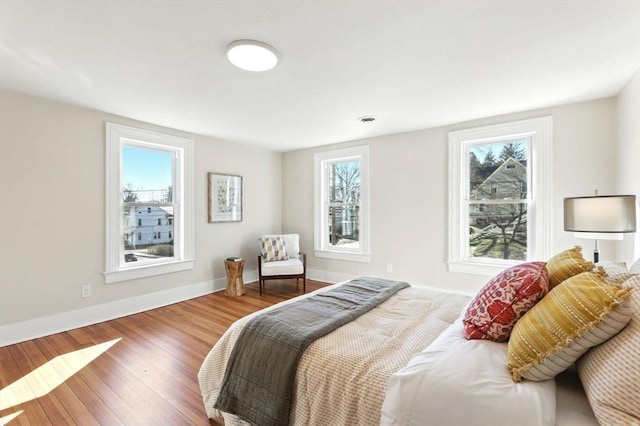 bedroom featuring baseboards and wood finished floors
