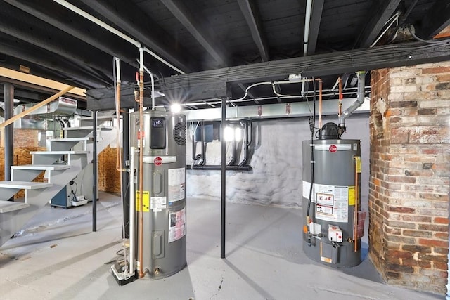 unfinished below grade area featuring gas water heater, stairway, and water heater