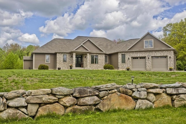 craftsman-style house featuring a front lawn, a garage, and roof with shingles