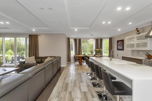 living area featuring recessed lighting and baseboards
