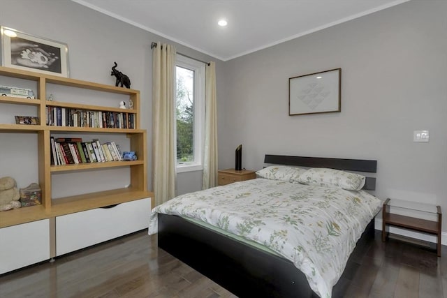 bedroom featuring dark wood-style flooring, crown molding, and recessed lighting