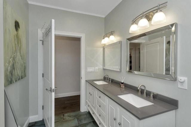 bathroom featuring baseboards and double vanity