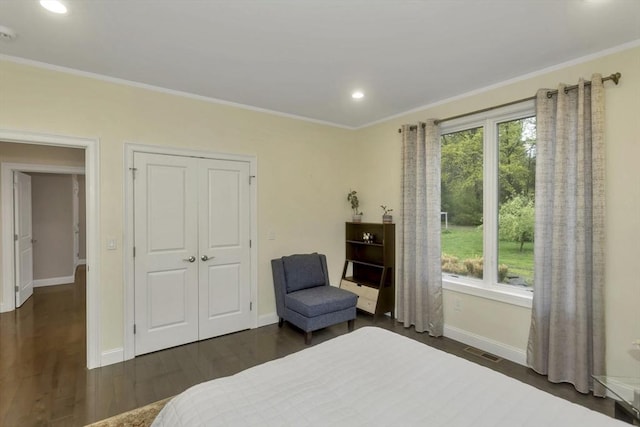 bedroom with baseboards, recessed lighting, ornamental molding, dark wood-style flooring, and a closet