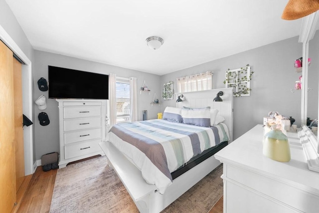 bedroom featuring light wood-style flooring and a closet