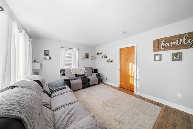 living area with wood finished floors and baseboards