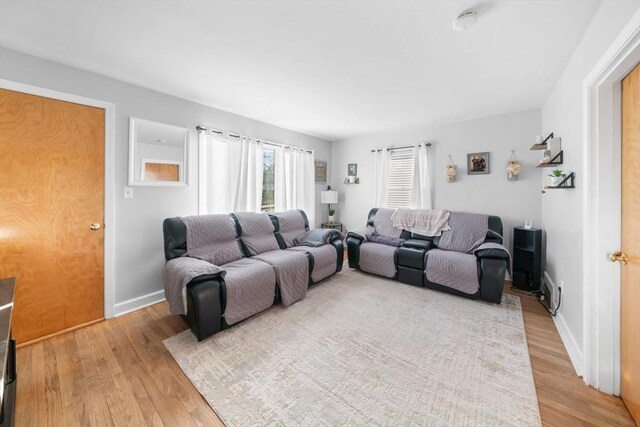 living room featuring light wood-type flooring and baseboards