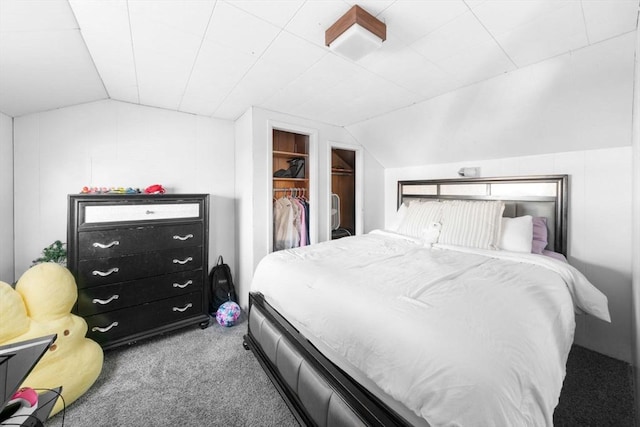 bedroom with lofted ceiling, a walk in closet, and carpet