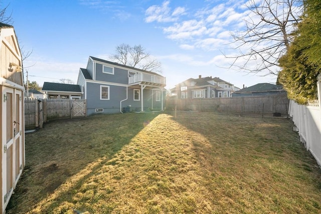 back of house featuring a lawn and a fenced backyard