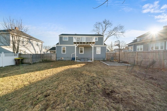 back of property featuring a fenced backyard and a lawn