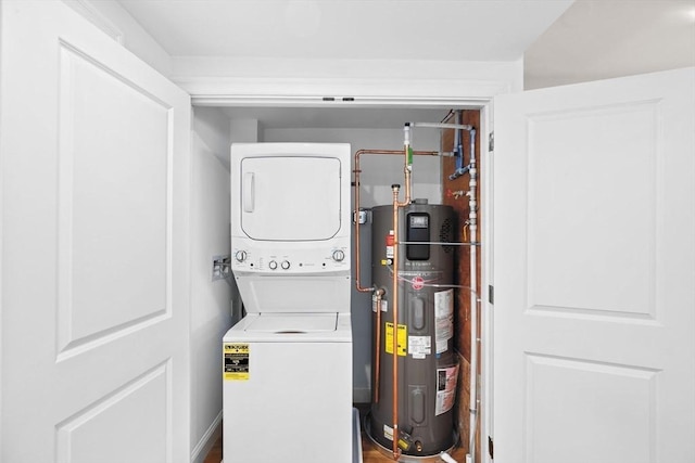 1 Pleasant St Unit 204, Cohasset, MA 02025 - clothes washing area featuring water heater, stacked washer and dryer, and laundry area