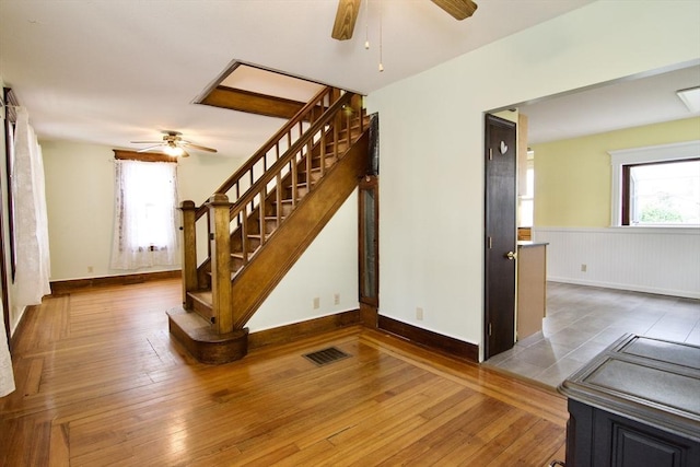82 Worcester St, West Springfield, MA 01089 - stairway with ceiling fan, wainscoting, healthy amount of natural light, and wood-type flooring