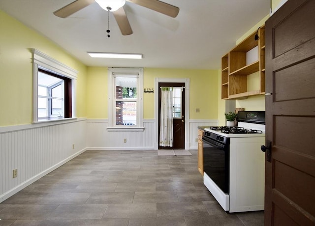 82 Worcester St, West Springfield, MA 01089 - kitchen featuring range with gas stovetop, wainscoting, a ceiling fan, and open shelves